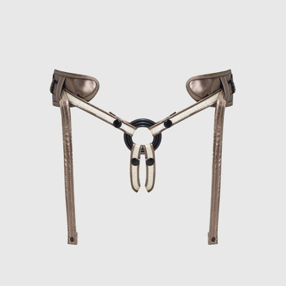 Metallic harness with leather straps on a light gray background