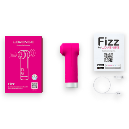 A pink handheld personal massager shown with its bright pink LOVENSE retail box, a white LOVENSE Fizz by LOVENSE card, and a white charging cable on a plain white background.