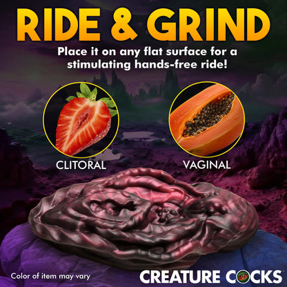 Creature Cocks Xeno Pussy - Silicone Vulva Grinder with 'Ride & Grind' text and images of a strawberry and papaya, set against a dark background.